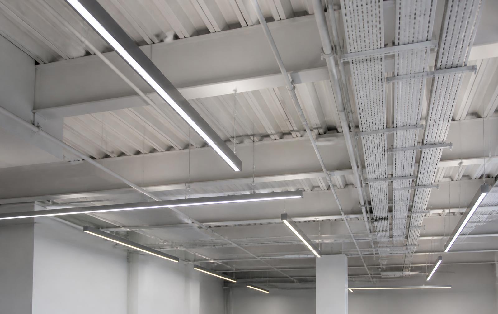 LED lighting and conduit runs across a modern commercial ceiling.
