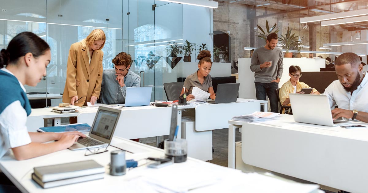 Group of individuals working on their computers in the office