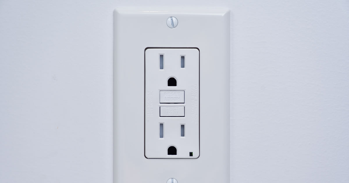 Electrical outlet with GFCI reset switch