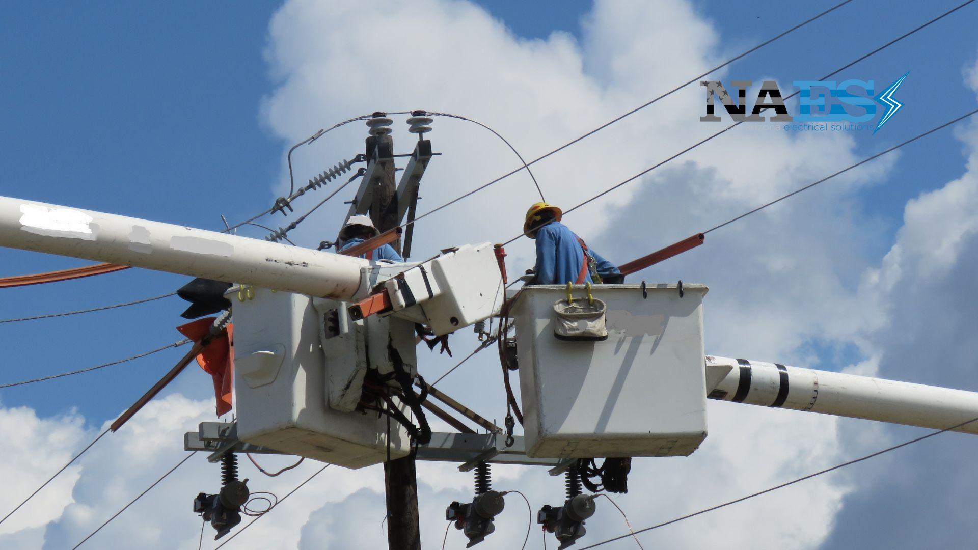 Certified utility line technicians inspecting external power lines and transformers to confirm infrastructure availability for a three-phase electrical installation.