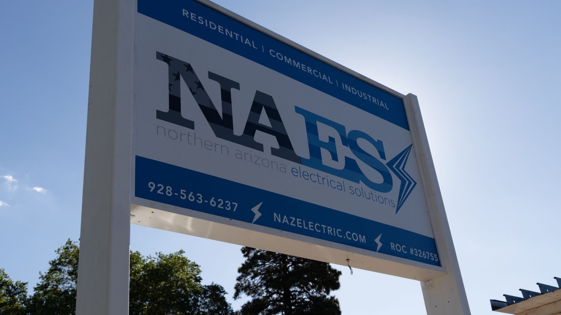 Outdoor business sign of an electrical services company operating in Flagstaff, Northern Arizona.