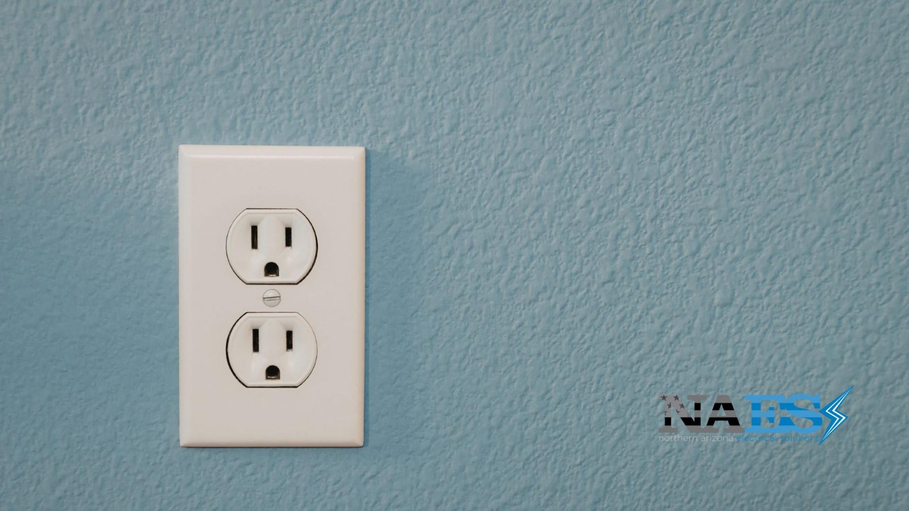 Loose wall outlet showing potential electrical connection and safety issues